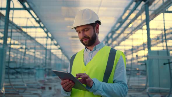 Happy Engineer with Tablet Collecting Production Data Analysing Efficiency alt