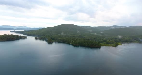 Mountain lake Turgoyak at sunset aerial view