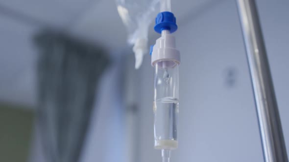 Close up view of dripping medicine in drip equipment working in hospital room alt