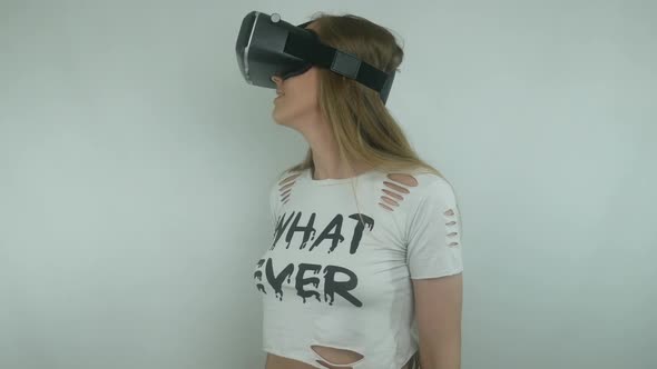 Sexy Woman Uses A Virtual Reality Helmet And Full Immersion Technology