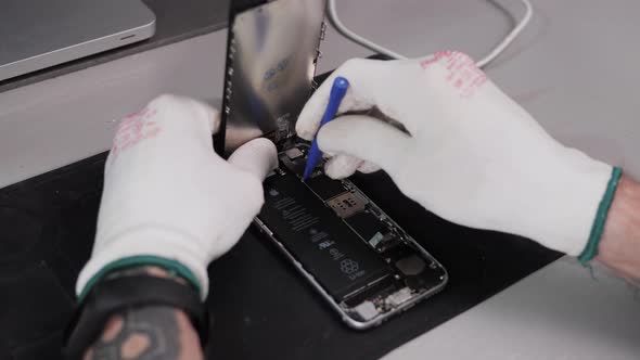 A Man is Taking a Spare Mobile Phone That Still Works in Use and Has Been Recycle alt