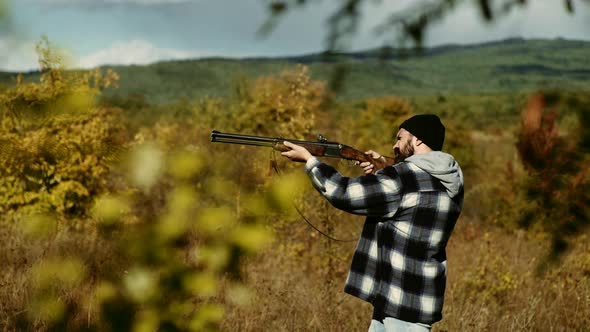 Autumn Hunting Season. Man with Gun. Hunting Licenses. Poacher with Rifle Spotting Some Deers alt
