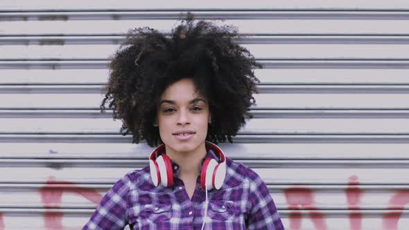 Portrait of pretty Afro American Female on street looking to camera