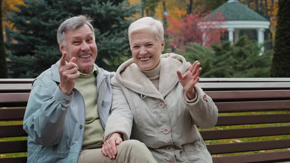 Caucasian Married Couple Family Retired 60s People Man Woman Waving Hands Hello Goodbye Gesture alt