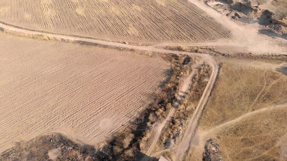 4k Aerial view of dry farmland before cultivation with path trail in Mexico - drone flying shot alt