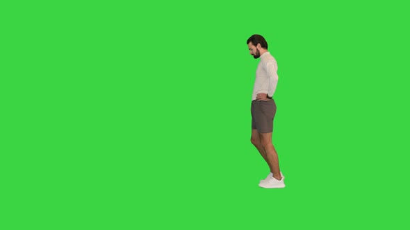 Young Man Runners Stretching Legs Warming Up on a Green Screen Chroma Key