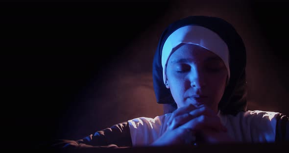 Nun Praying In The Dark