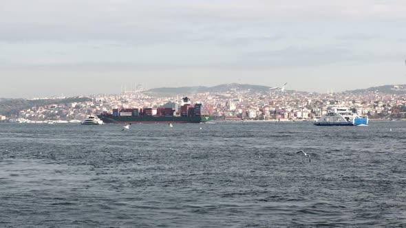 Container ship and ferry boats at Istanbul Bosphorus in slow motion 