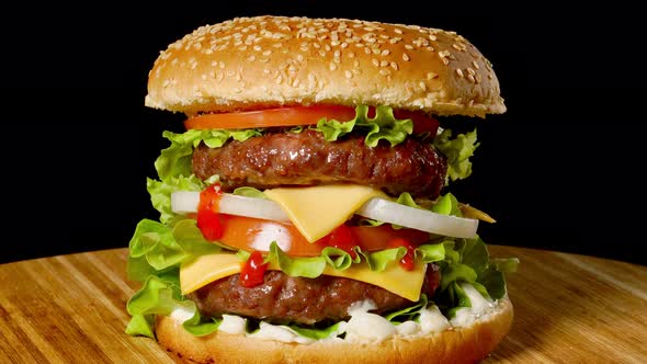 Cheeseburger with Bacon on a Dark Background. Close-up. Macro Shooting. alt