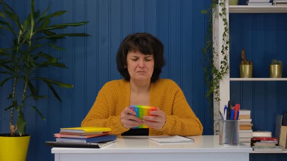 Middle Aged Woman Popping Pop It Antistress Silicone Toy alt