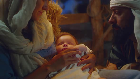 Mary and Joseph Admiring Sleeping Baby Jesus alt