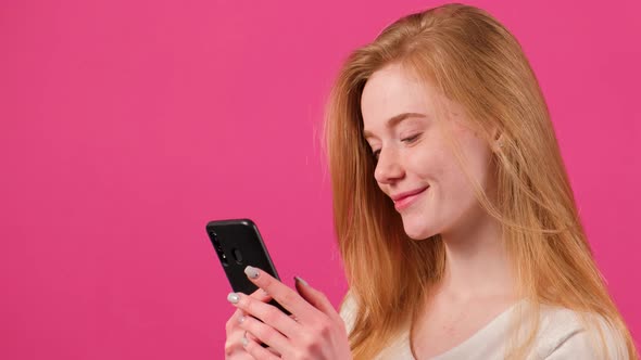 Happy Red Hared Woman with Freckles Making Selfie on Pink Background alt