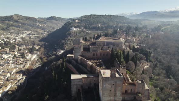 Strategically placed Alhambra palace complex on hill, Spain; drone pullback