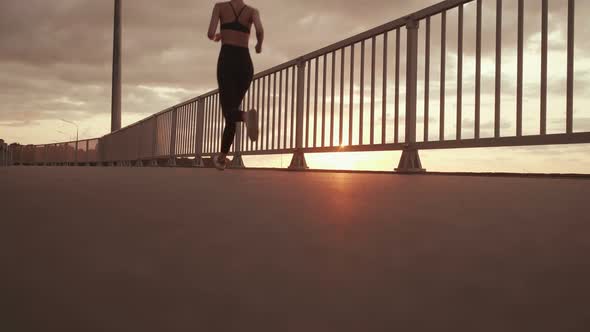 Girl Running on the Background of the Sunset