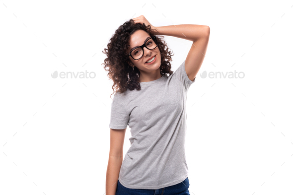 adorable slim curly brunette promoter woman with glasses dressed in gray basic t-shirt with logo