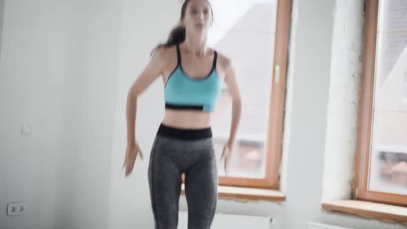 Young Fit Brunette Girl in Sportswear Does Exercises