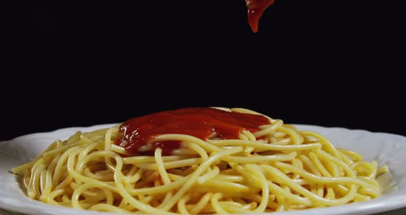 Pouring Tomato Sauce On Pasta 77b