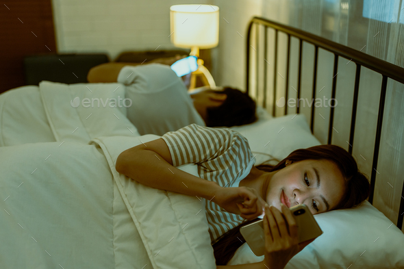 Asian young phone addict couple don\'t pay attention with each other.