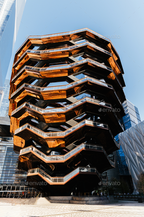 Exterior of modern spiral structure against skyscrapers in daylight ...