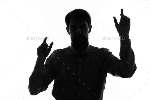 The man in a suit with a pistol in hand crime hand gesture isolated background