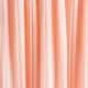 delicate chic textile background of peach color. pleats of chiffon