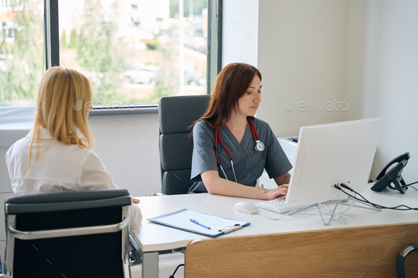 Physician is entering patient information into electronic health record