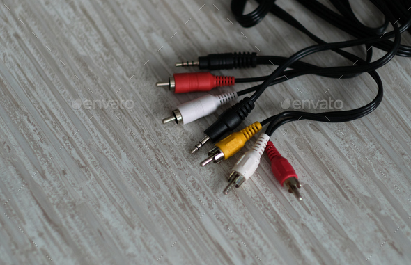 RCA cables, with their distinctive colors, sit ready to transmit audio and video signals, a nod to