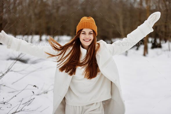 woman in winter clothes in a hat fun winter landscape There is a