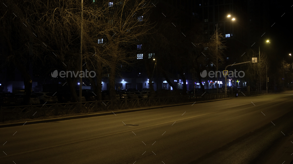 Night city street with a moving police car with flashing lights and siren. Concept. Concept of crime