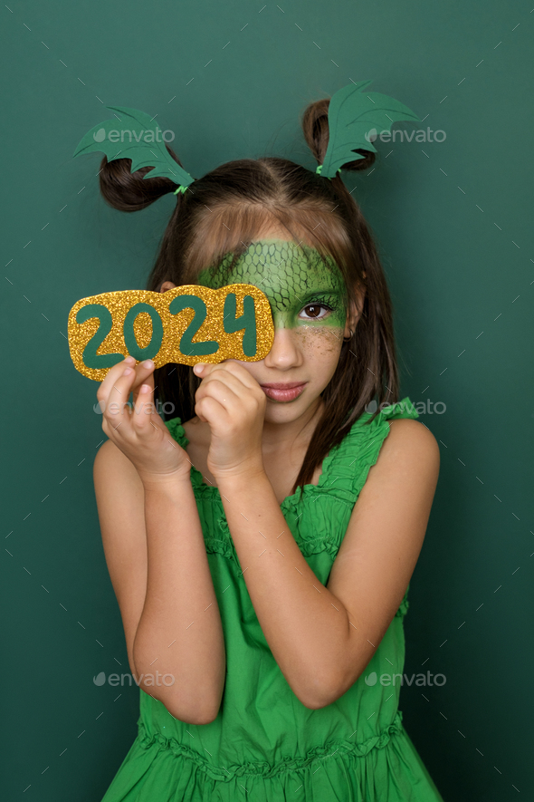 Beautiful girl with dragon scale pattern on face closes eye with the number 2024