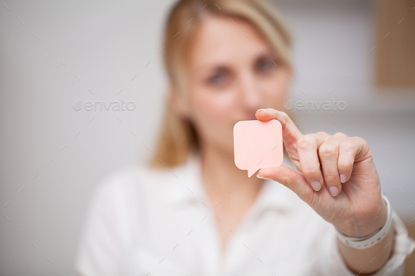 Woman hand holding square blank clean sticker mock up.