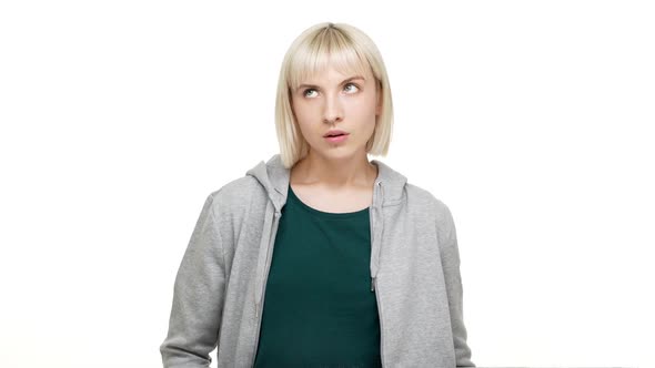 Portrait of Serious Annoyed Shorthaired Blondie 20s Looking on Camera Apathetically Rolling Blue alt