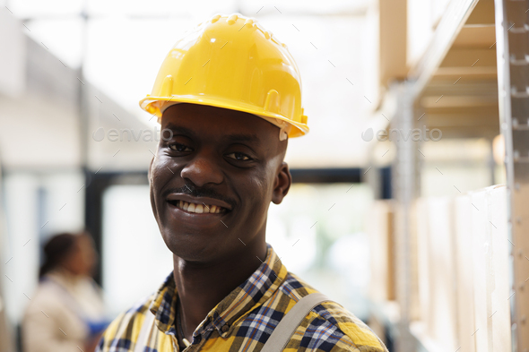 African american warehouse package handler in yellow helmet portrait