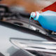 Pouring winter washer fluid into car reservoir during winter, protecting it from freezing. - PhotoDune Item for Sale