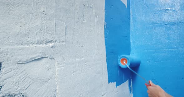 Close Up of Blue Paint Applied to White Wall with Roller Home Repairs alt