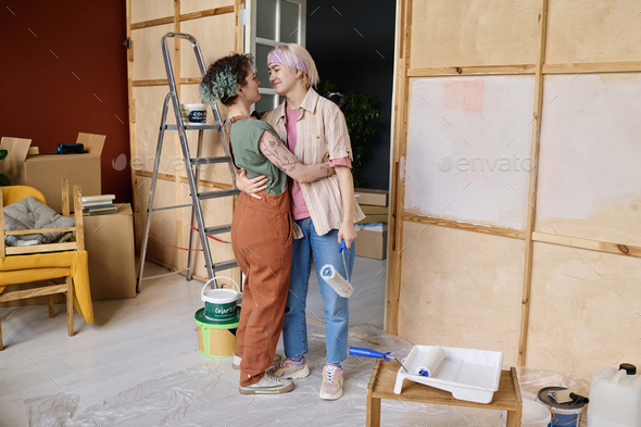 Lesbian couple making repair in new apartment