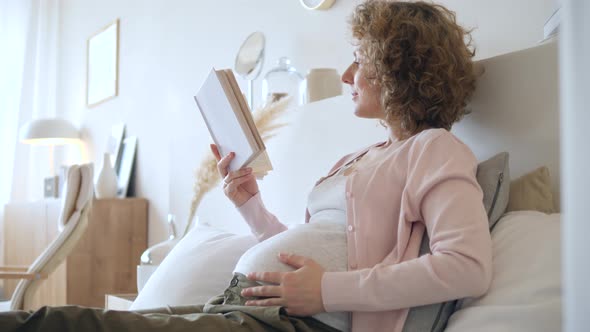 Pregnancy And Relaxation Concept. Pregnant Woman Reading At Home. alt