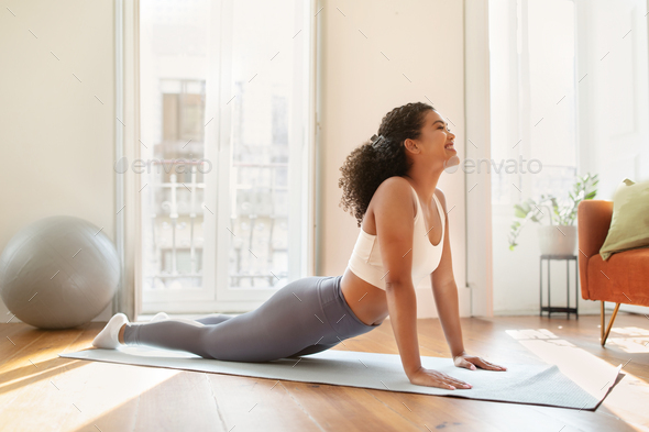 lady on mat bending back into yoga asana indoors Stock Photo by  Prostock-studio