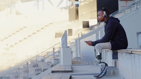 Disabled athletic listening music on mobile phone 4k alt