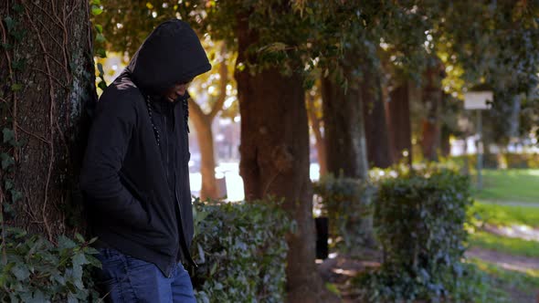 Black african dealer selling dose to young drug addicted woman in the park alt