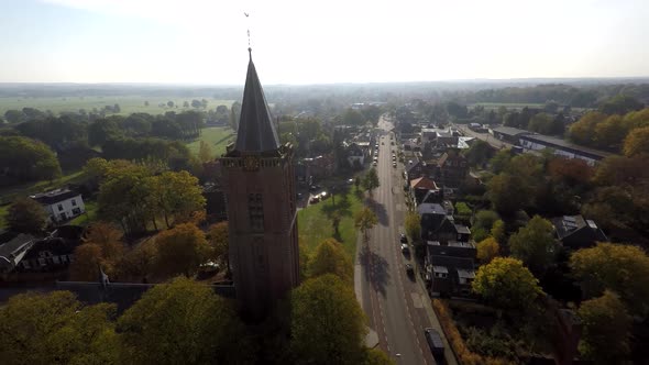 Church in rural area next to road - Drone moving away alt