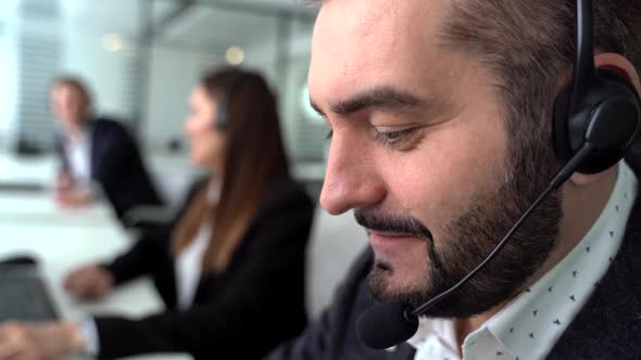 Handsome Young Male Customer Support Executive Working in Office Close Up