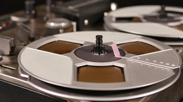 Vintage Reel to Reel tape recorder playing music close up of reel alt