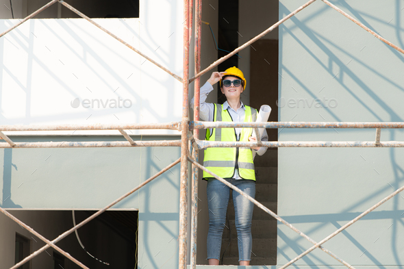Engineer or architect working on the construction site, double-checking plans and process. - Stock Photo - Images