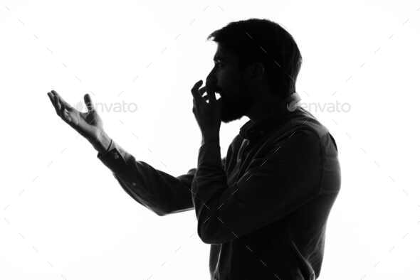 The man in a suit with a pistol in hand crime hand gesture isolated background
