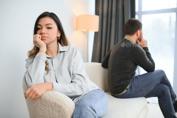 Man and woman feeling stressed and angry at each other, frustrated couple sitting back to back