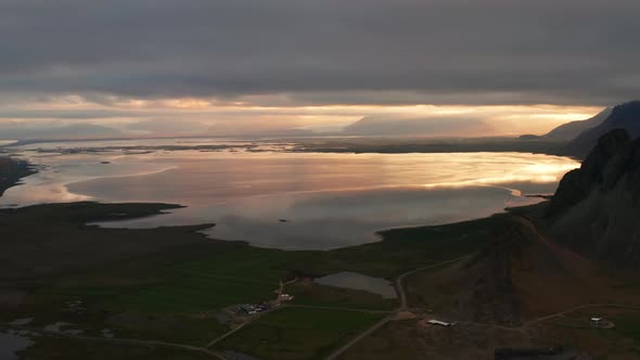Drone Over Landscape And Out To Sea At Sunset alt