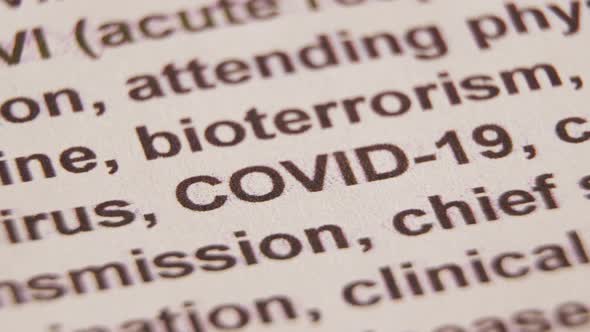 Macro shot of the word "covid-19" highlighted with a yellow marker