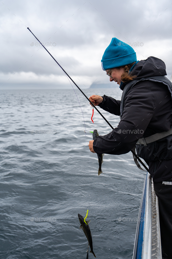 Happy Female Angler Displaying Her Fishing Success in the Norwegian Sea,  Favorite Hobby Stock Photo by VidEst