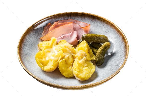 Melted Raclette Swiss cheese with boiled potato and ham. Isolated on white background.
